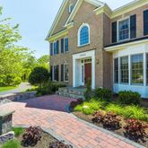 a front view of a house with a yard and plants
