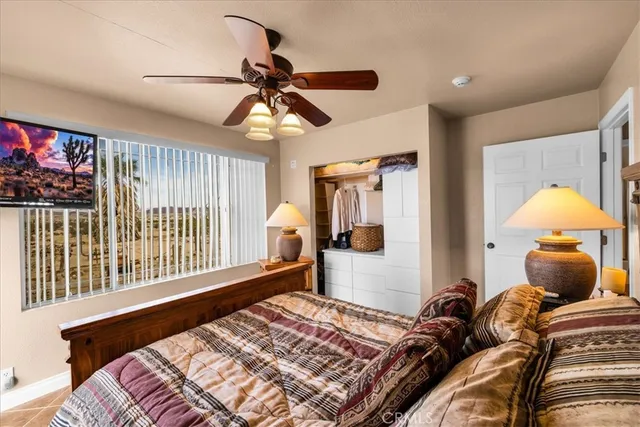 a bedroom with a large bed and a chandelier
