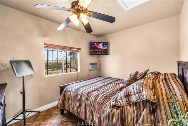 a bedroom with a bed and painting on the wall