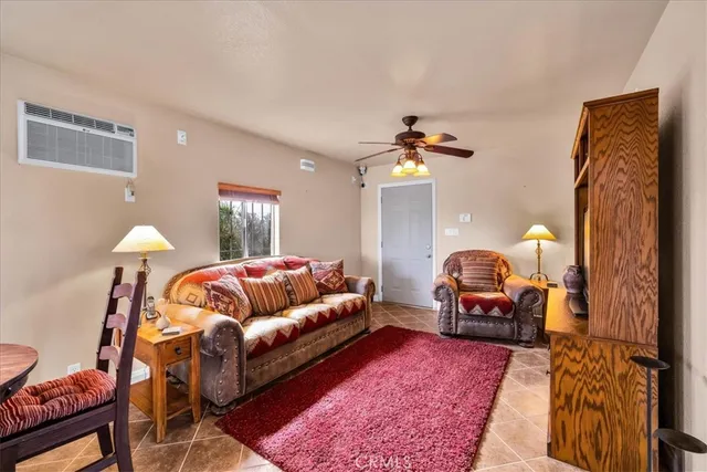 a living room with furniture a rug and a lamp