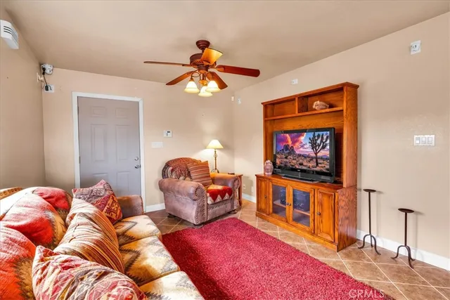 a bedroom with furniture and a flat screen tv
