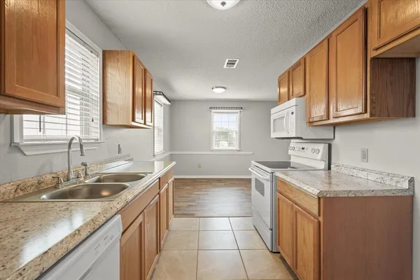 a kitchen with a sink stove and cabinets