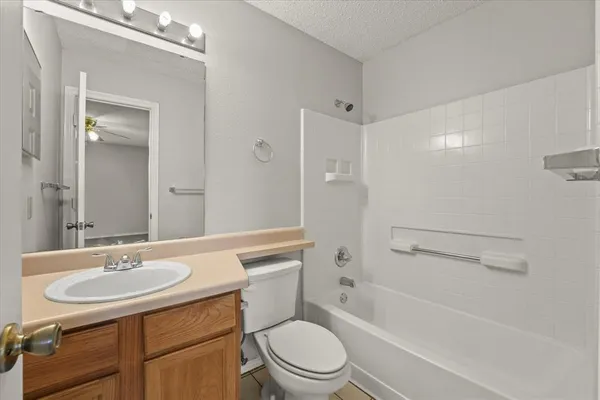 a bathroom with a sink toilet a mirror and shower