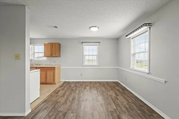 wooden floor in an empty room with a window and wooden floor