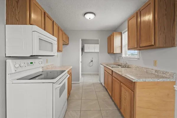 a kitchen with a sink stove top oven and cabinets