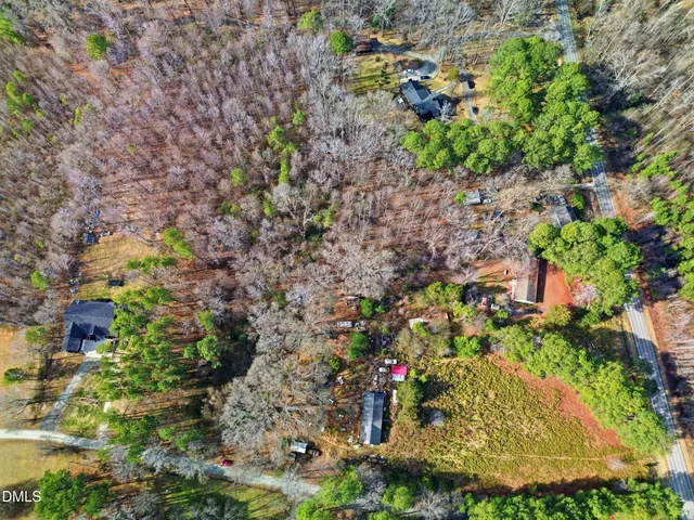 an aerial view of a houses with a yard