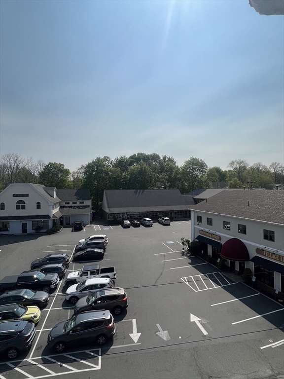 21 Bessom Street, Unit 6 Marblehead, MA 01945 - Photo 12 of 12 a view of a city street with a car parked