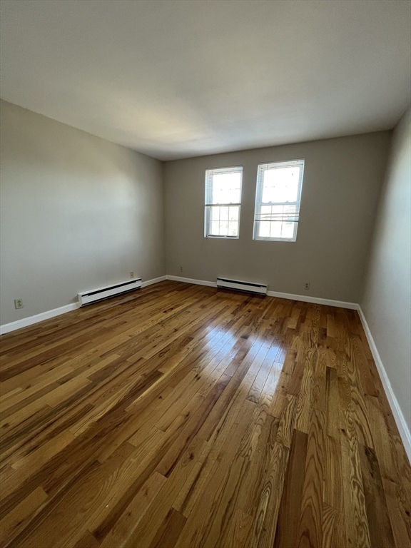 21 Bessom Street, Unit 6 Marblehead, MA 01945 - Photo 10 of 12 a view of empty room with wooden floor and fan