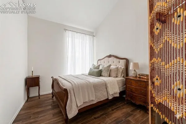 a bedroom with a bed and wooden floor