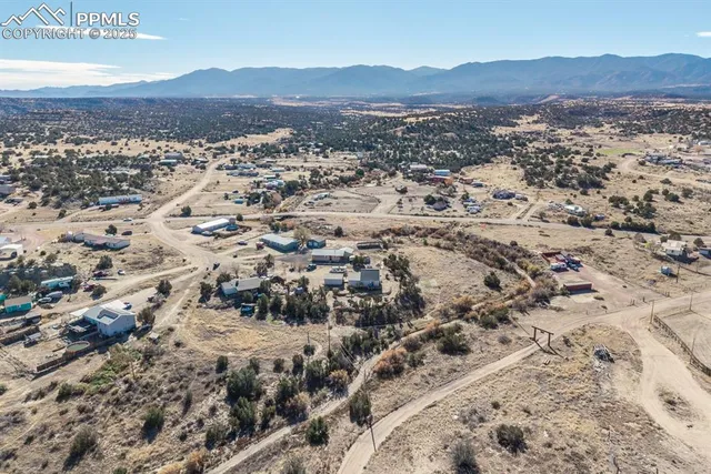 an aerial view of a house with a yard
