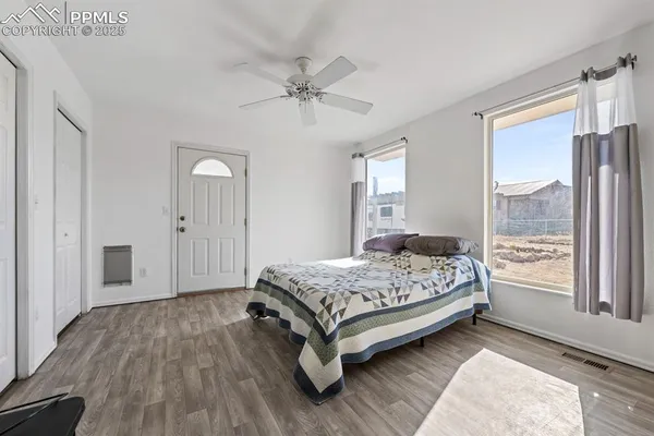 a bedroom with a bed and large window