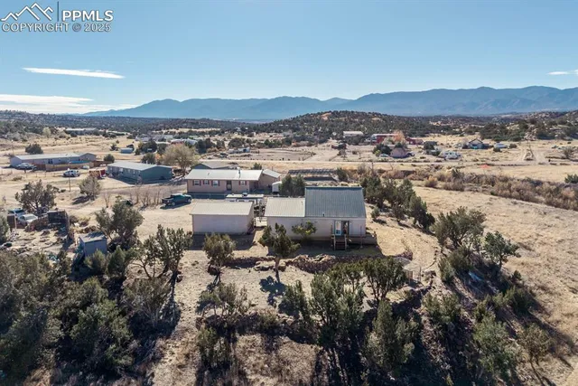 an aerial view of a house with a beach