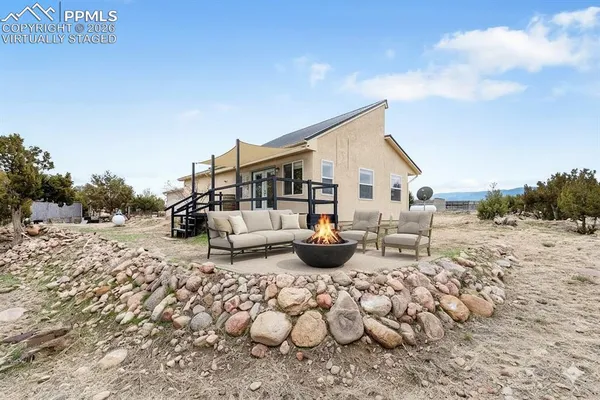 a view of a house with backyard porch and sitting area