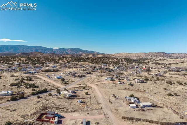 a view of a large mountain with a mountain in the background