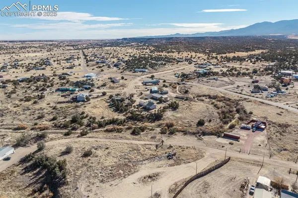 a living room with couches and a fireplace with wooden floor
