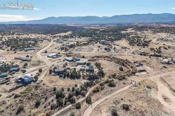 an aerial view of a house with a yard