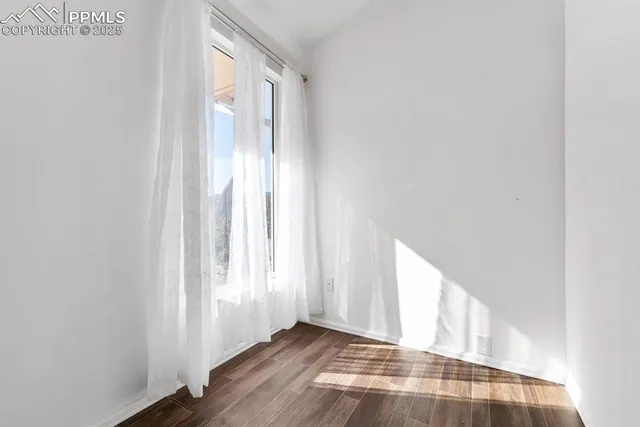 a bedroom with a large bed and a flat tv screen on dresser