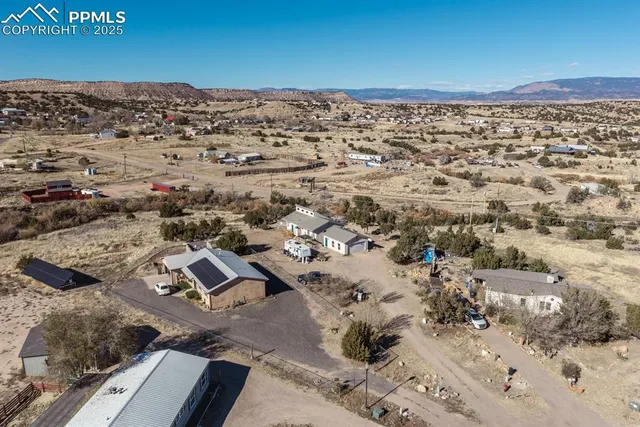 an aerial view of houses with a yard