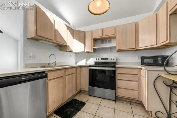 a kitchen with cabinets stainless steel appliances and a sink