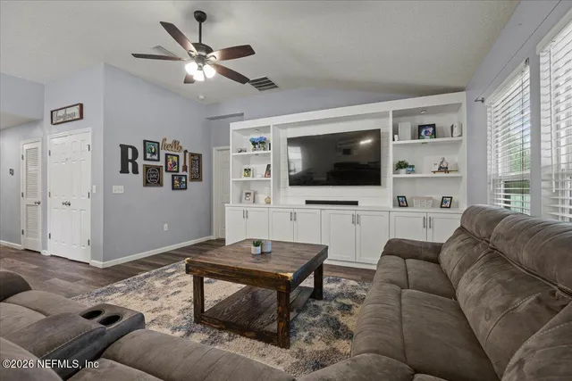 a living room with furniture and a flat screen tv