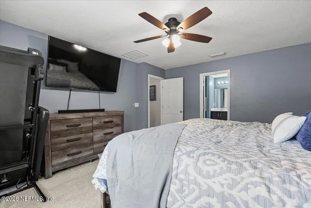 a bed room with a bed and a television