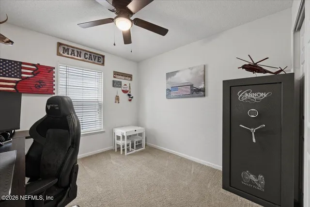 a livingroom with furniture and a ceiling fan