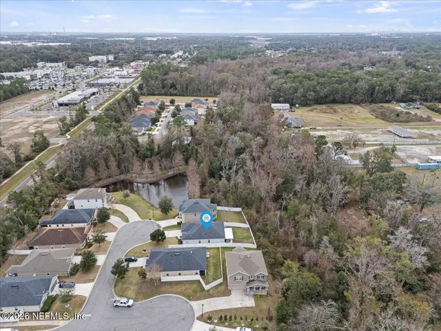 an aerial view of a house with a mountain