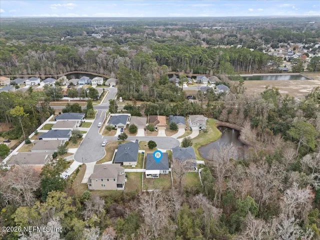 an aerial view of a house with a lake view