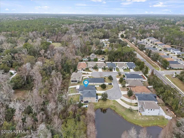 an aerial view of residential houses with outdoor space