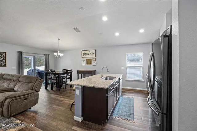 a living room with furniture a dining table and kitchen view