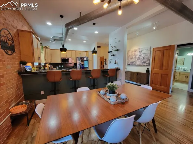 a view of a dining room with furniture and wooden floor