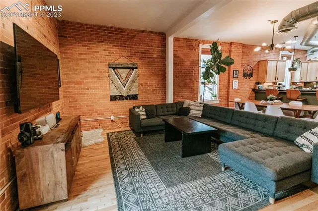 a living room with couches coffee table and chairs