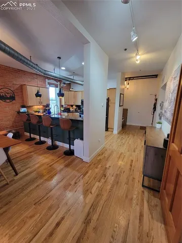 a view of a workspace with furniture and a kitchen