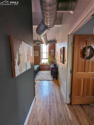 a kitchen with stainless steel appliances granite countertop a refrigerator a stove and a wooden floors