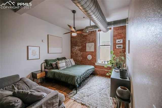 a bedroom with bed and ceiling fan