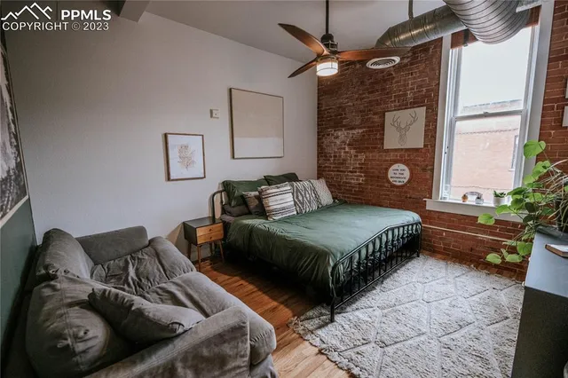 a bedroom with a bed couch and a window