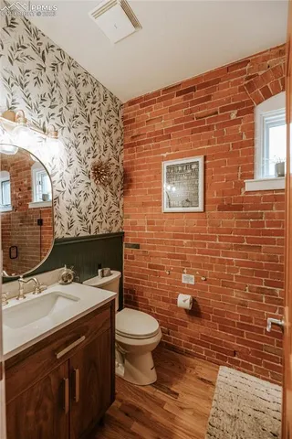 a bathroom with a sink a toilet and mirror