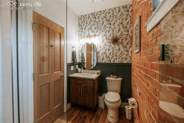 a bathroom with a toilet sink and mirror