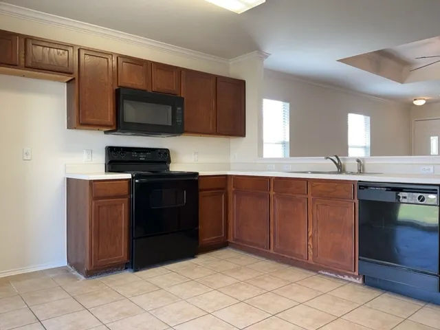 a kitchen with stainless steel appliances granite countertop a stove and a microwave