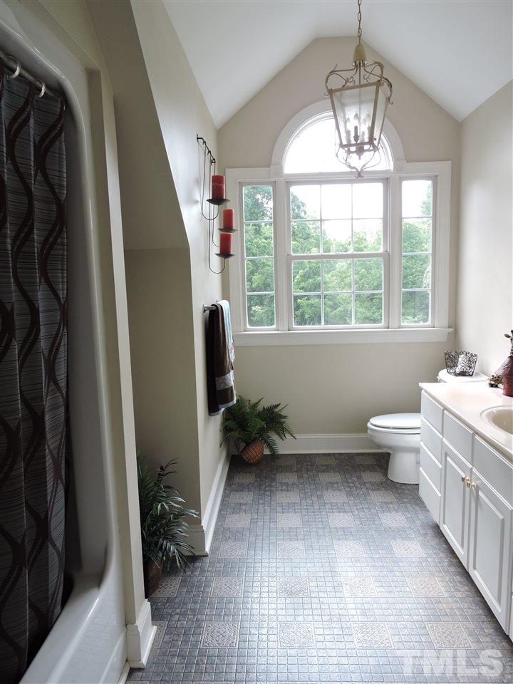1409 Mill Hill Road Roxboro, NC 27574 - Photo 14 of 25 a view of a bathroom with bathtub and window
