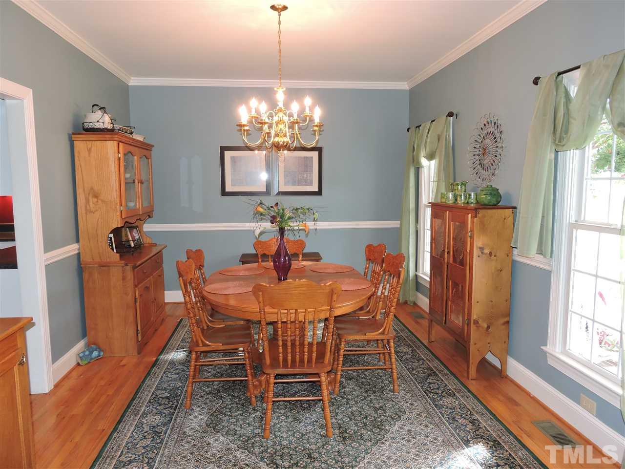 1409 Mill Hill Road Roxboro, NC 27574 - Photo 5 of 25 a view of a dining room with furniture a chandelier and wooden floor