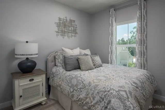 a bedroom with a bed and window