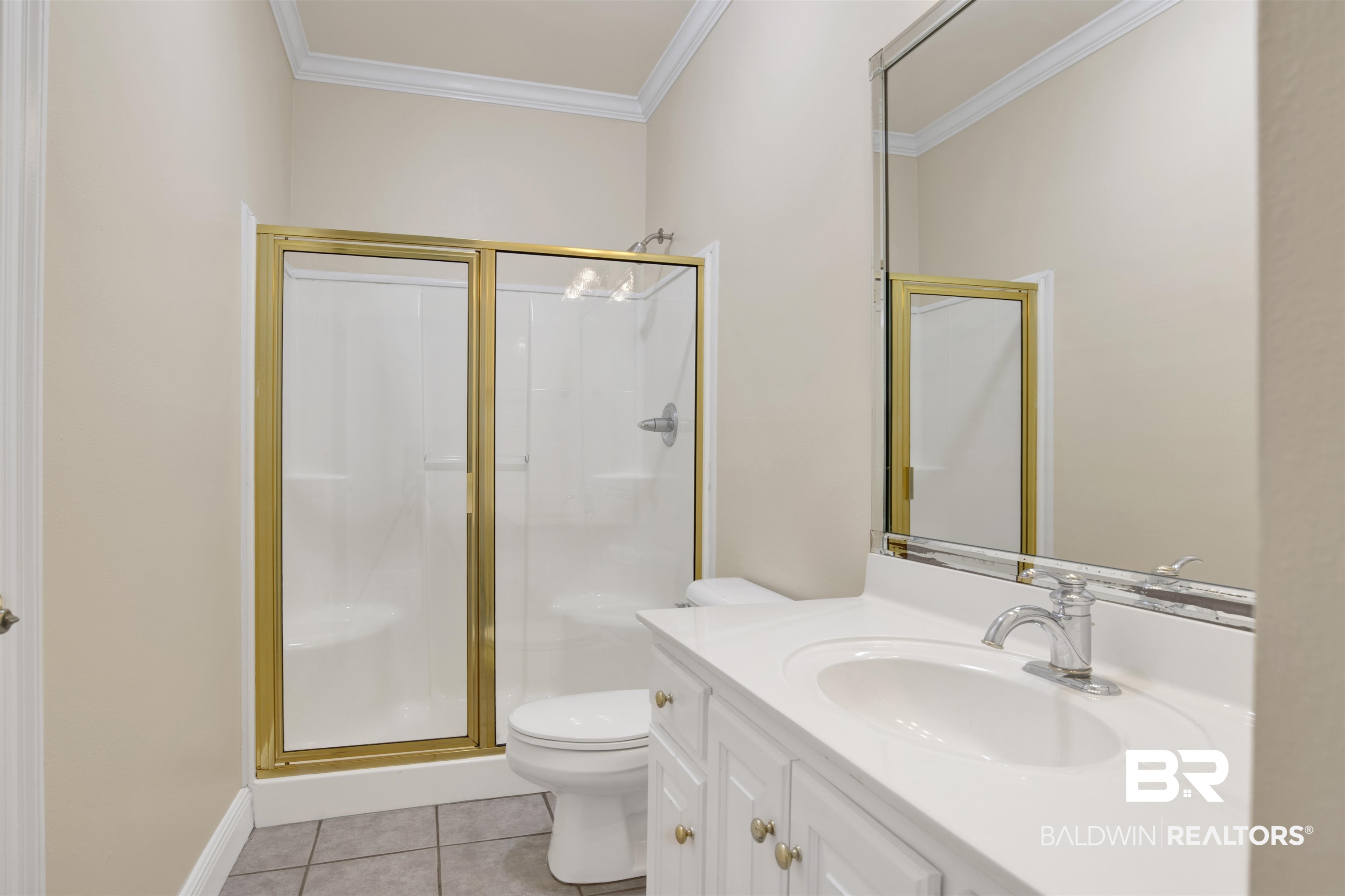 8847 Dawes Lake Road South Mobile, AL 36619 - Photo 19 of 47 Bathroom featuring a white vanity with an integrated sink, chrome faucet, and gold-framed shower enclosure