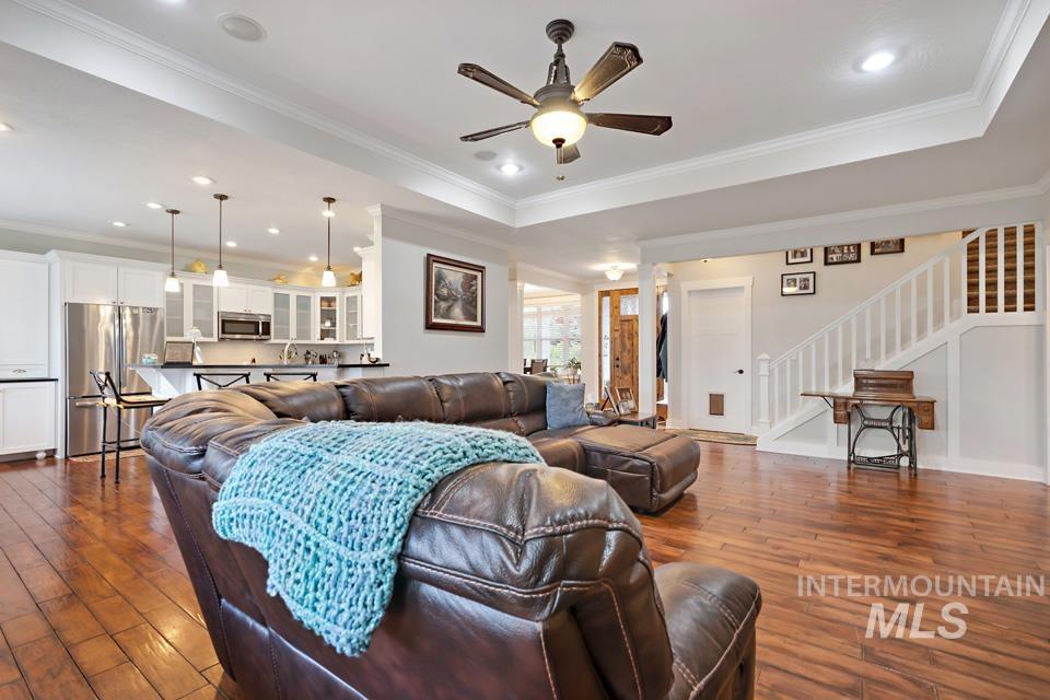 8271 Washoe Road Fruitland, ID 83619 - Photo 12 of 29 Open-concept living area featuring wood-finish flooring, a contemporary ceiling fan, recessed lighting, and crown molding