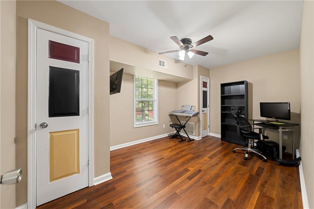 55 Meridian Point Dallas, GA 30132 - Photo 31 of 45 a view of a livingroom with a flat screen tv wooden floor and a ceiling fan