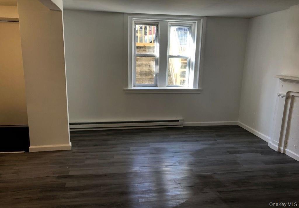 69 Lander Street Newburgh, NY 12550 - Photo 3 of 6 a view of a room with wooden floors and window