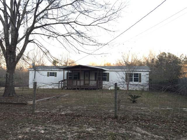 1948 Parker Road Cantonment, FL 32533 - Photo 2 of 28 a view of a house with a yard and a large tree