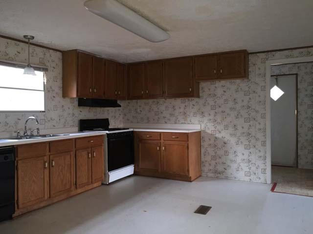 1948 Parker Road Cantonment, FL 32533 - Photo 15 of 28 a kitchen with a sink and cabinets