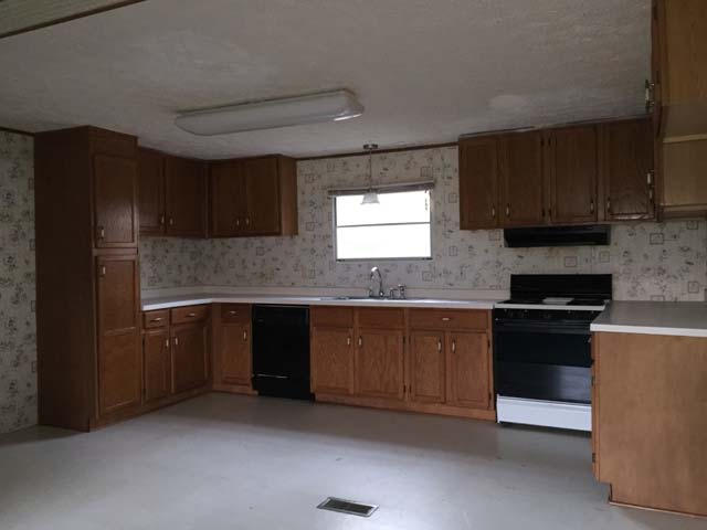 1948 Parker Road Cantonment, FL 32533 - Photo 16 of 28 a kitchen with stainless steel appliances granite countertop a stove a sink and a refrigerator