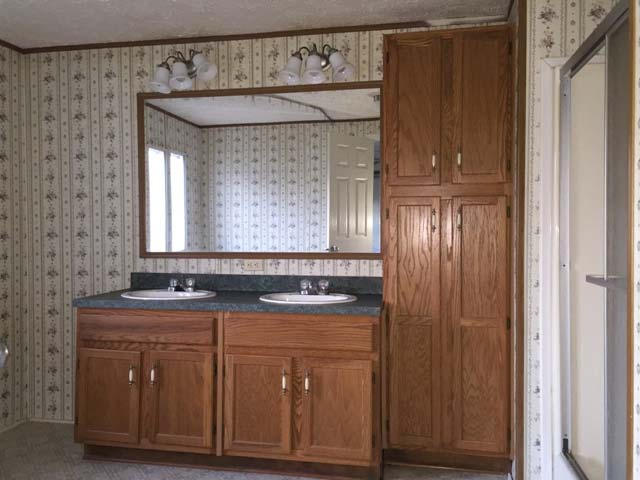 1948 Parker Road Cantonment, FL 32533 - Photo 21 of 28 a bathroom with a granite countertop sink and a mirror